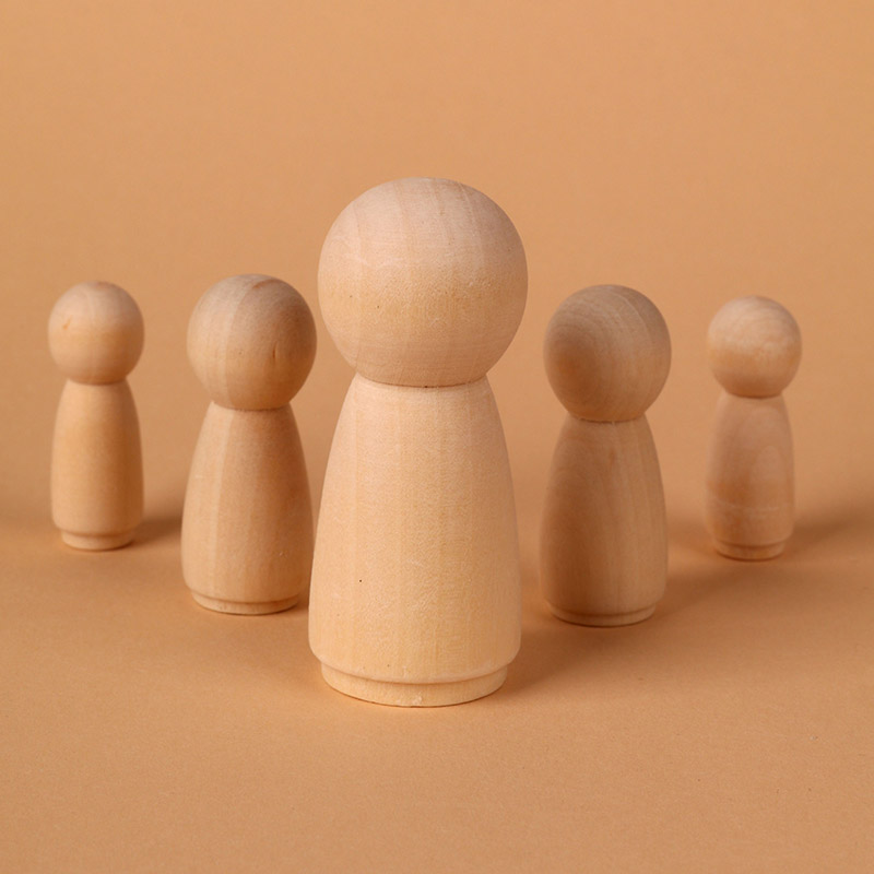 Group of wooden peg figures standing in a row, with one larger figure in front against an orange background, suggesting a team or crowd concept.